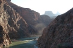 Looking East along the Colorado River at sunrise, the sun reflecting off a cloud of dust from a mule train.